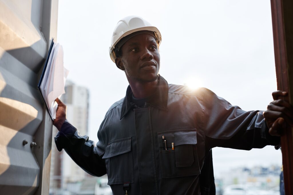 Worker opening container door